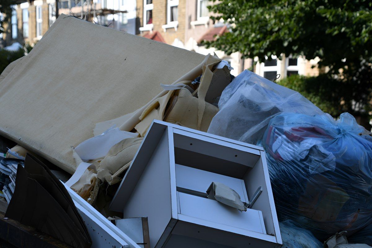 A Pile of Trash is Sitting in Front of a Building — Anderson Waste Services in Mittagong, NSW