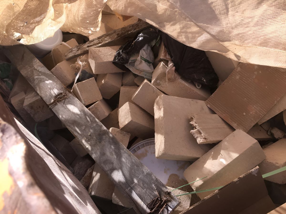 A Pile of Cardboard Boxes is Sitting in a Bag — Anderson Waste Services in Moss Vale, NSW
