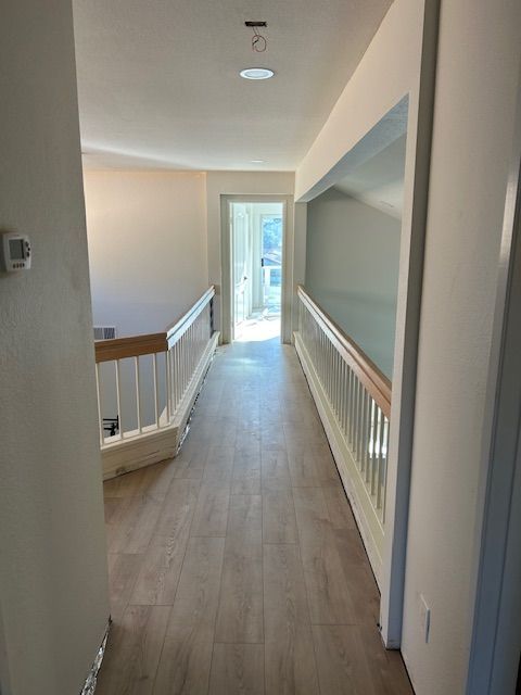 A long hallway leading to a staircase in a house in Otay Mesa
