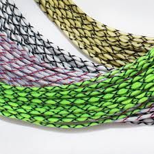 A bunch of different colored ropes are stacked on top of each other on a white surface.