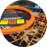 A close up of a badminton racket with orange strings