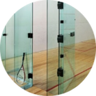 A squash racket is sitting on a wooden court in a circle.