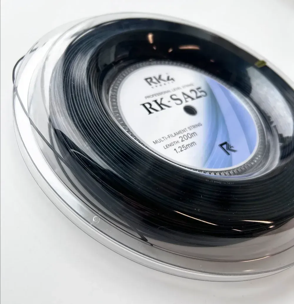 Spool of black tennis string with white label;