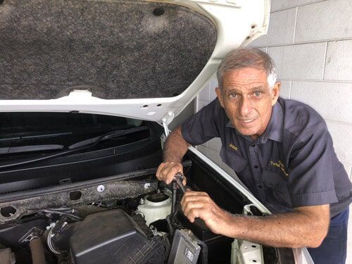 Car mechanic smiling — Mechanic in Cairns QLD