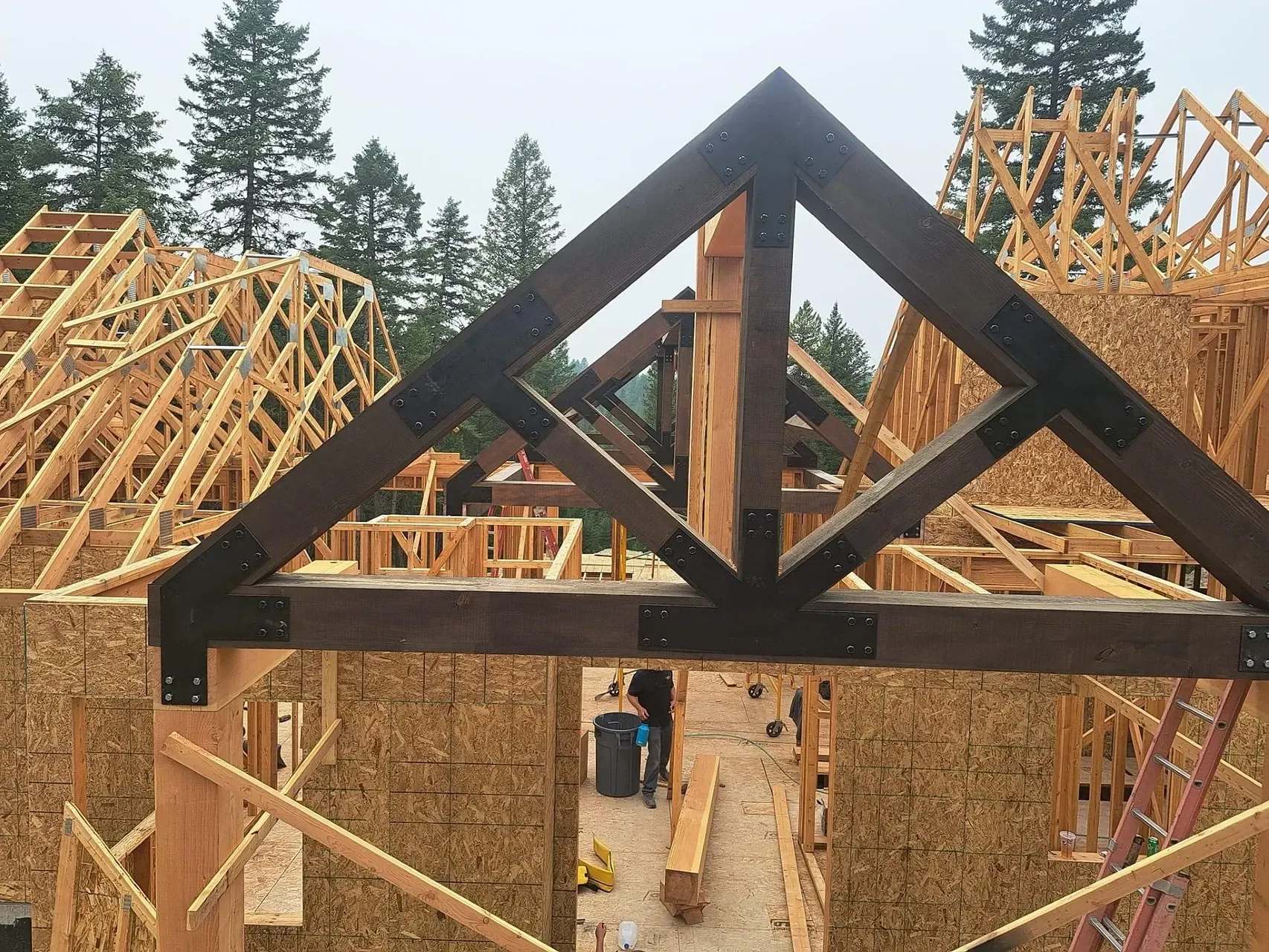 The roof of a house is being built with wooden beams.