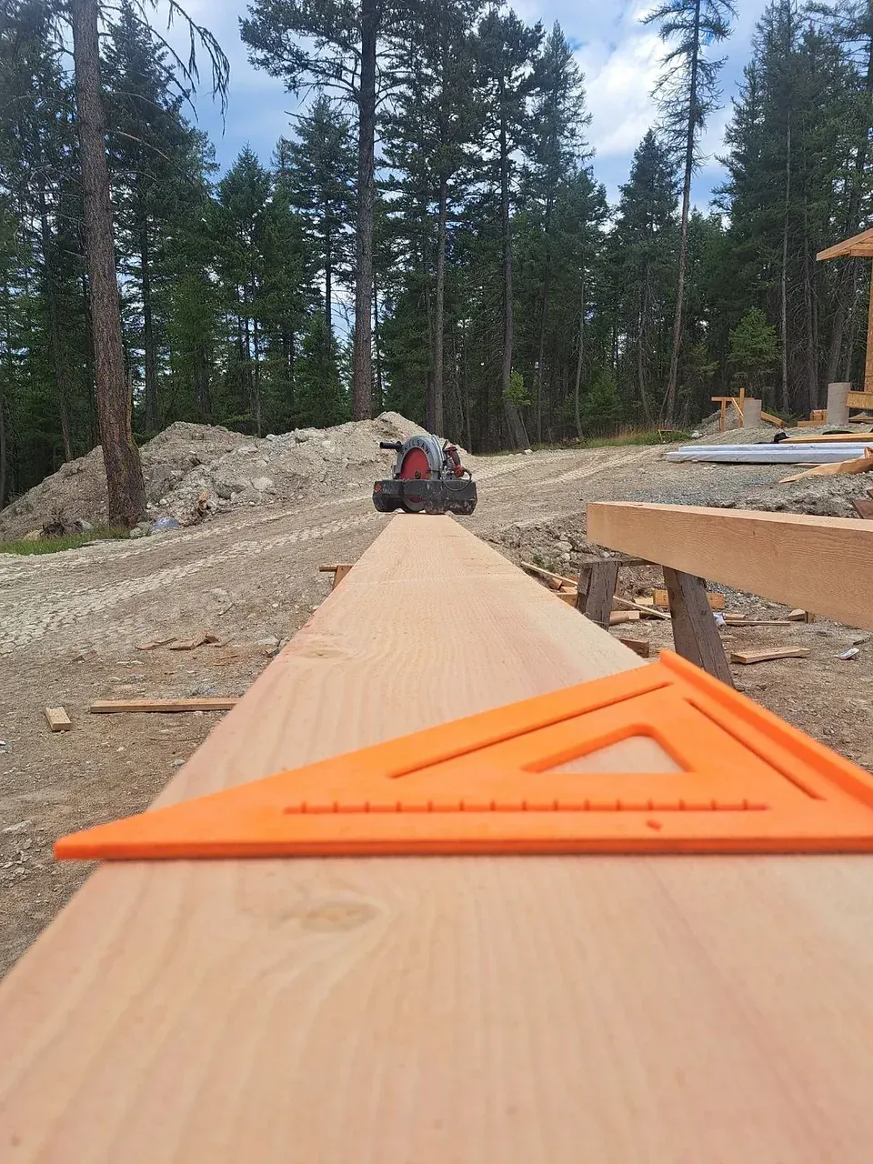 An orange triangle is sitting on top of a piece of wood.