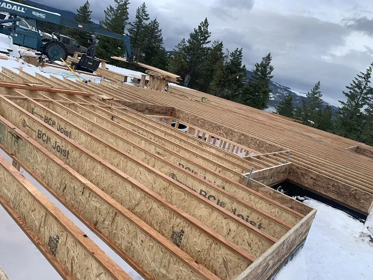 A house is being built on top of a snow covered field.