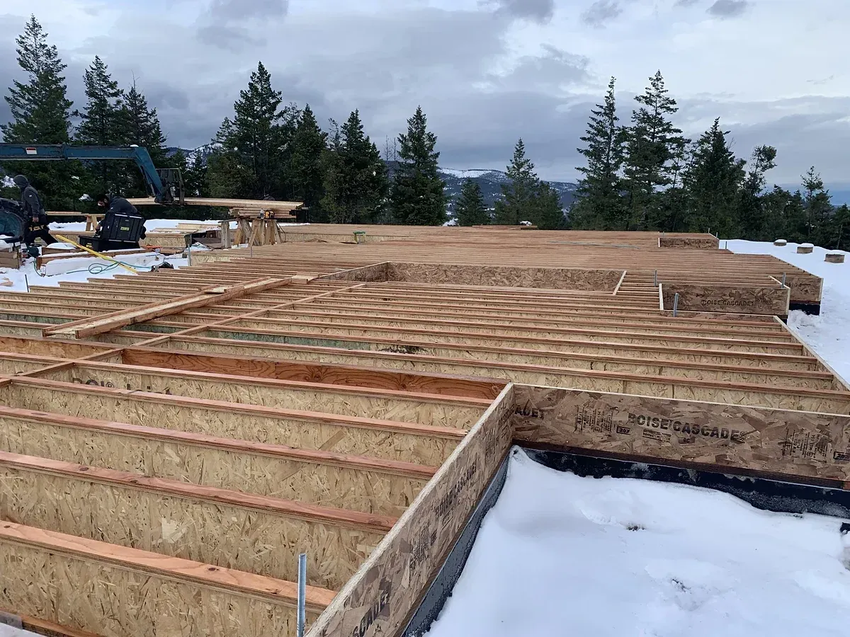 The foundation of a house is being built in the snow.