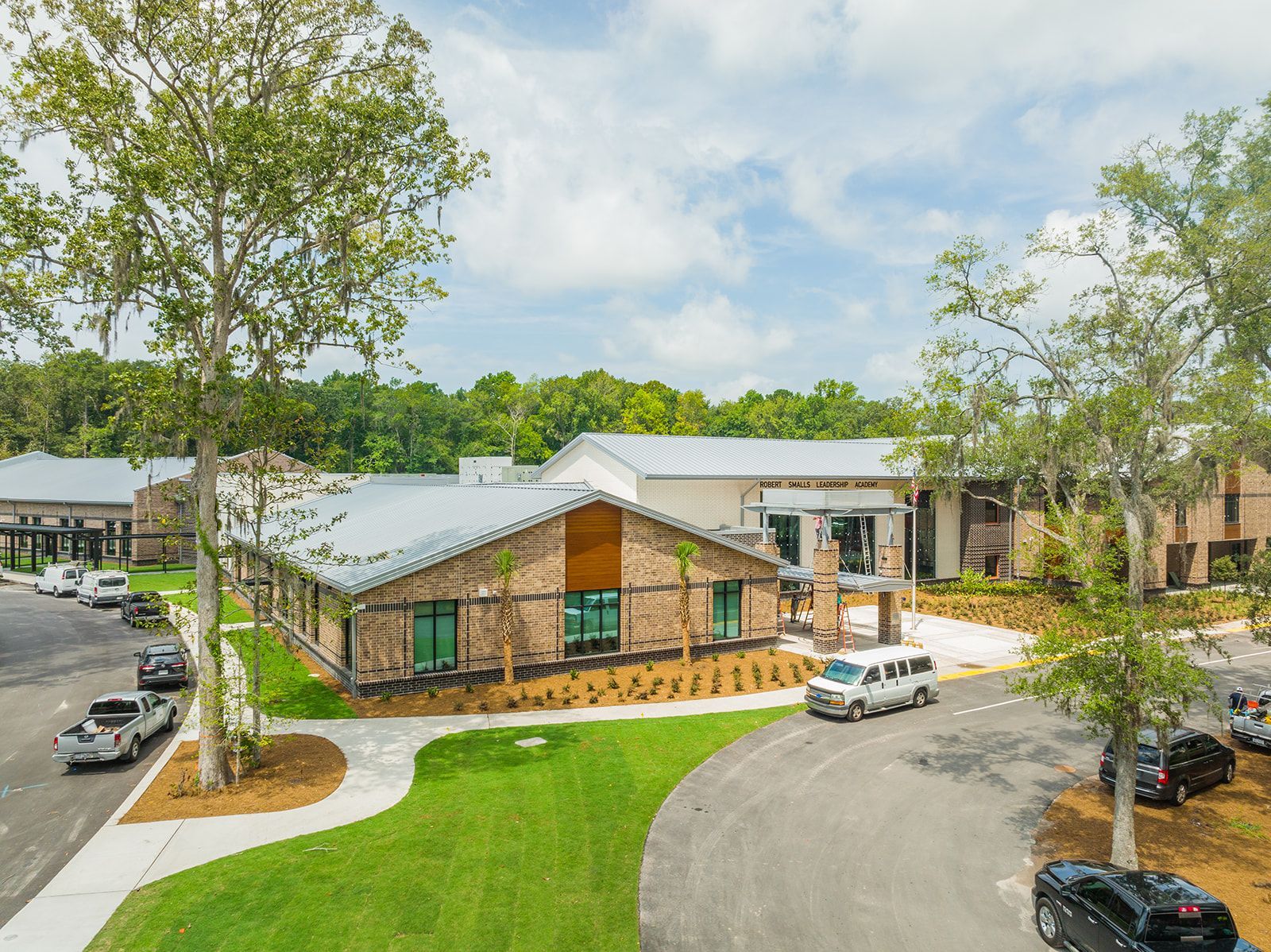 A large brick building , elementary school with the word gymnasium on it.