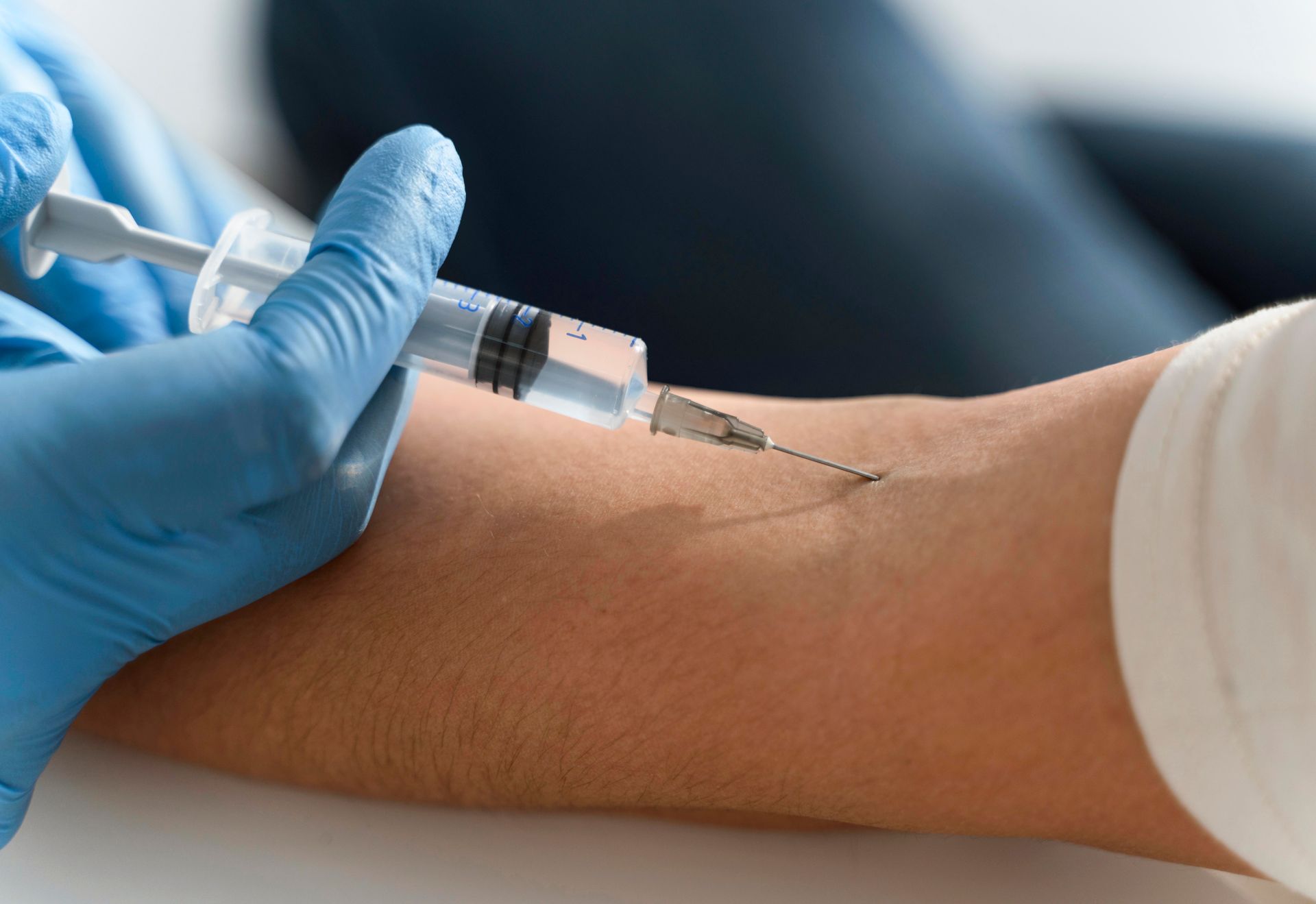 A person is getting an injection in their arm.