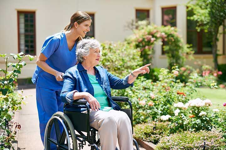 resident and a nurse outside in the retirement home garden