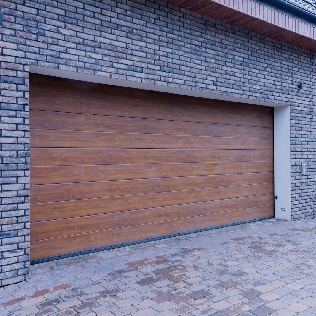 Brown garage door set in brick exterior.