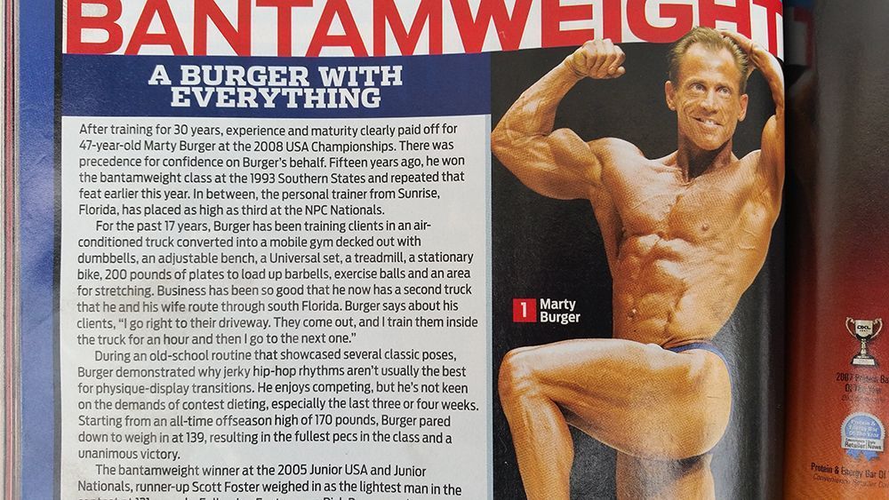 A magazine is open to a page that says bantamweight a burger with everything