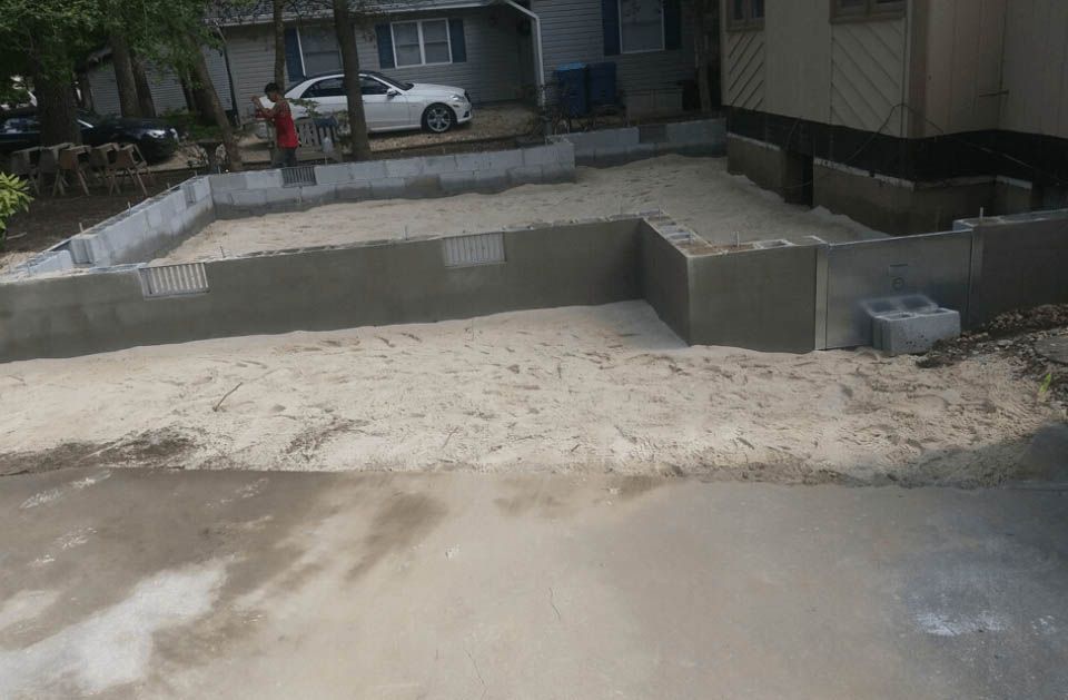 A white car is parked in the driveway of a house.