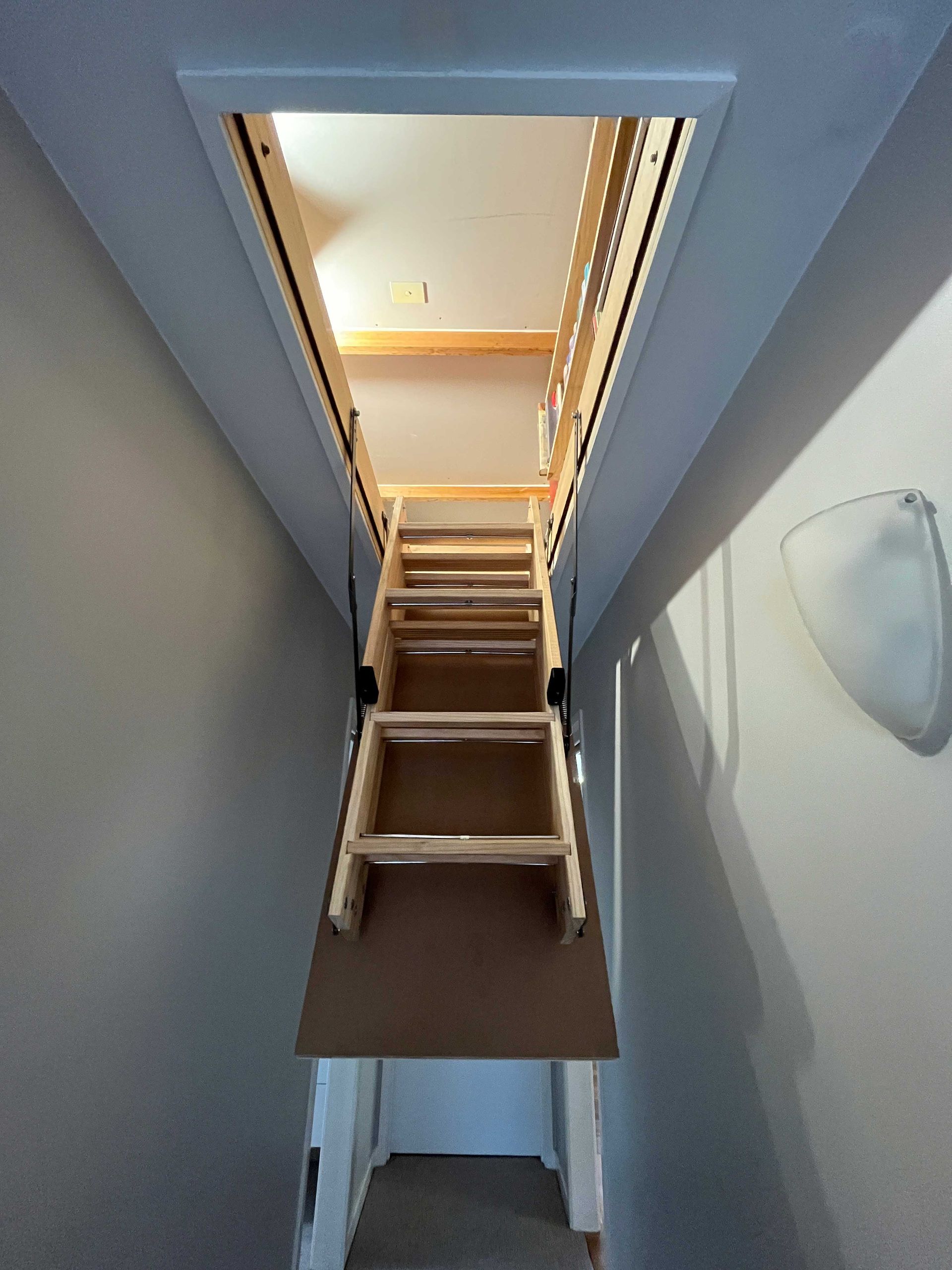 A wooden staircase leading up to the second floor of a house