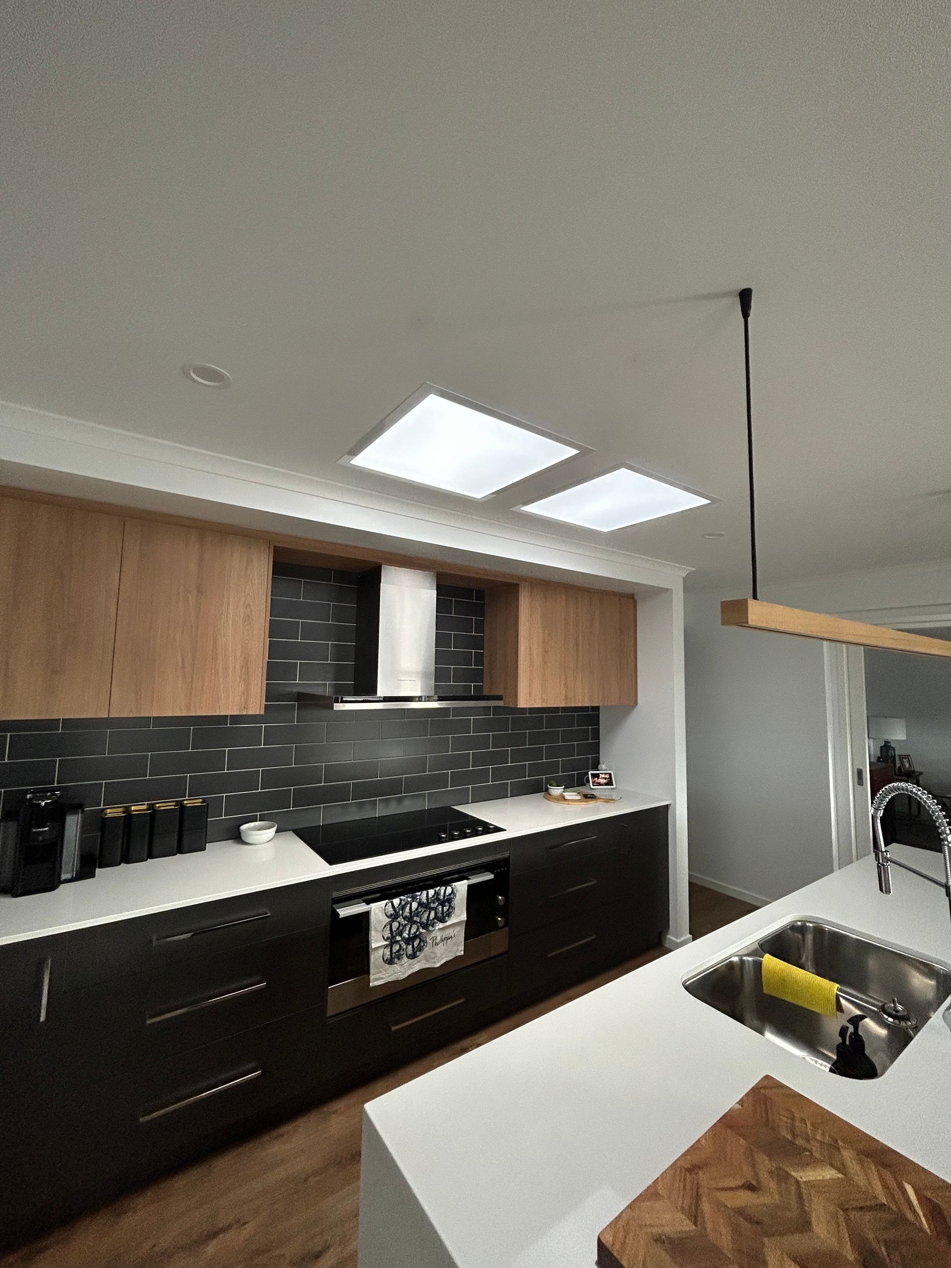 A kitchen with a sink and a stove top oven