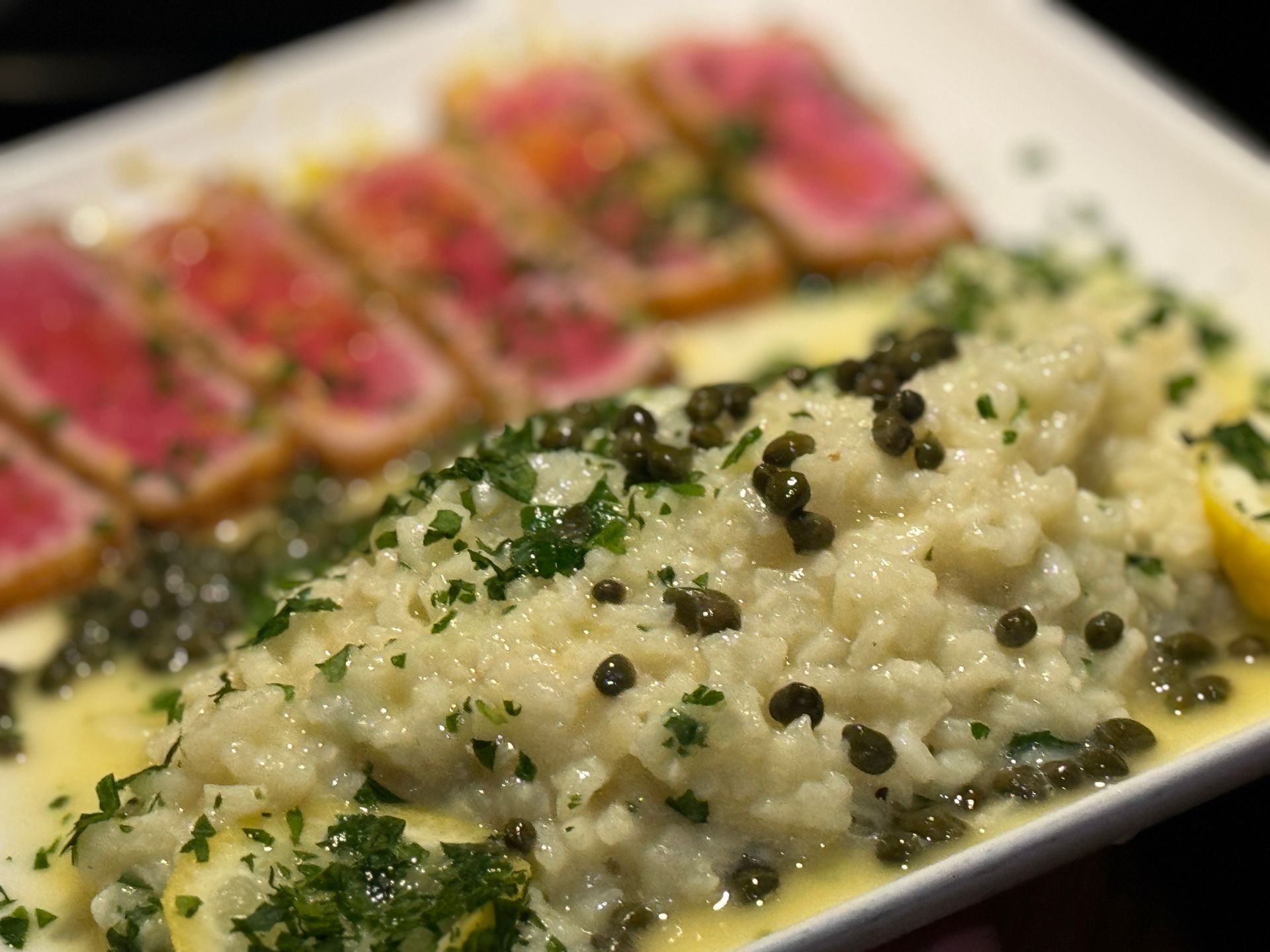 A close up of a plate of food with rice and meat