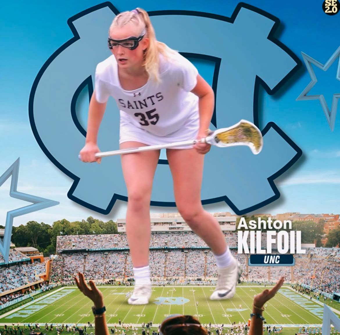 College commit photo of athlete in white shirt stepping in front of UNC University logo