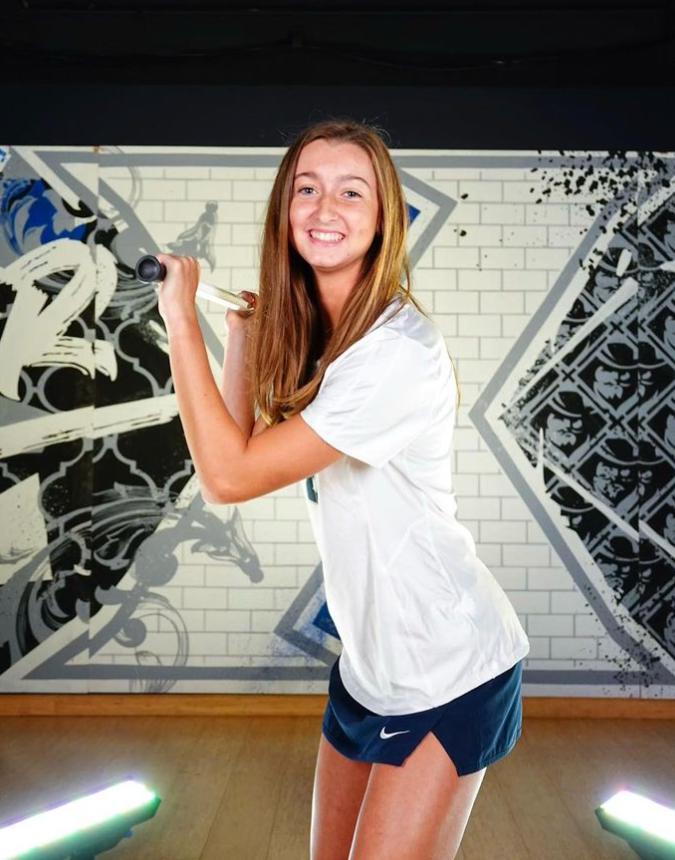 CAV Lax Elite athlete smiling in white shirt, standing in front of a black and white graffiti-style wall
