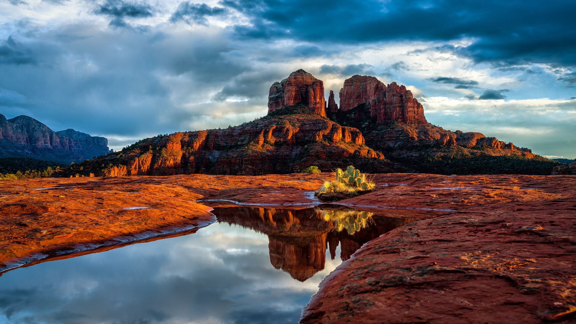 There is a mountain in the background and a river in the foreground.