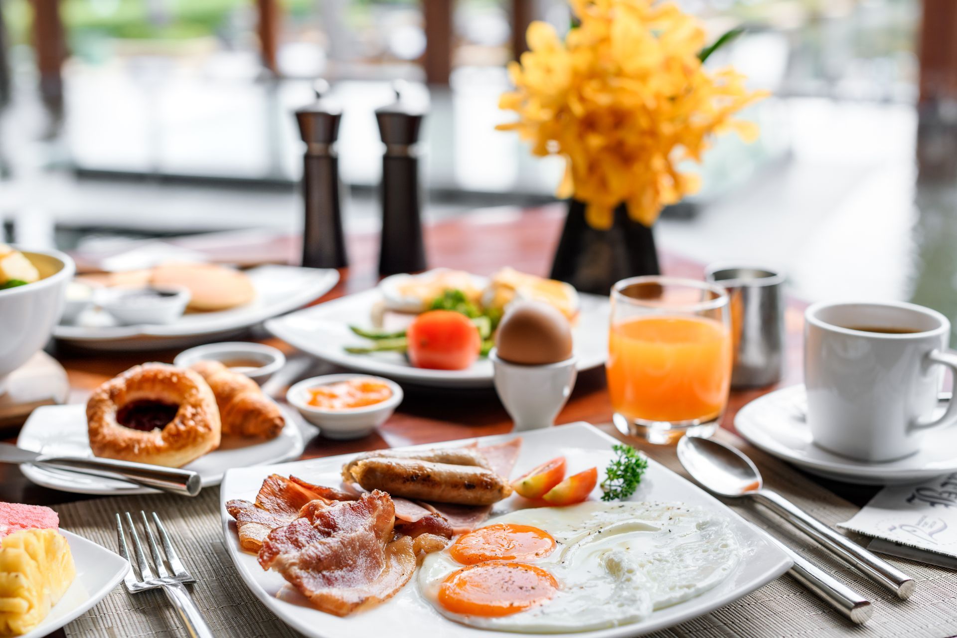 A table topped with plates of food and drinks.