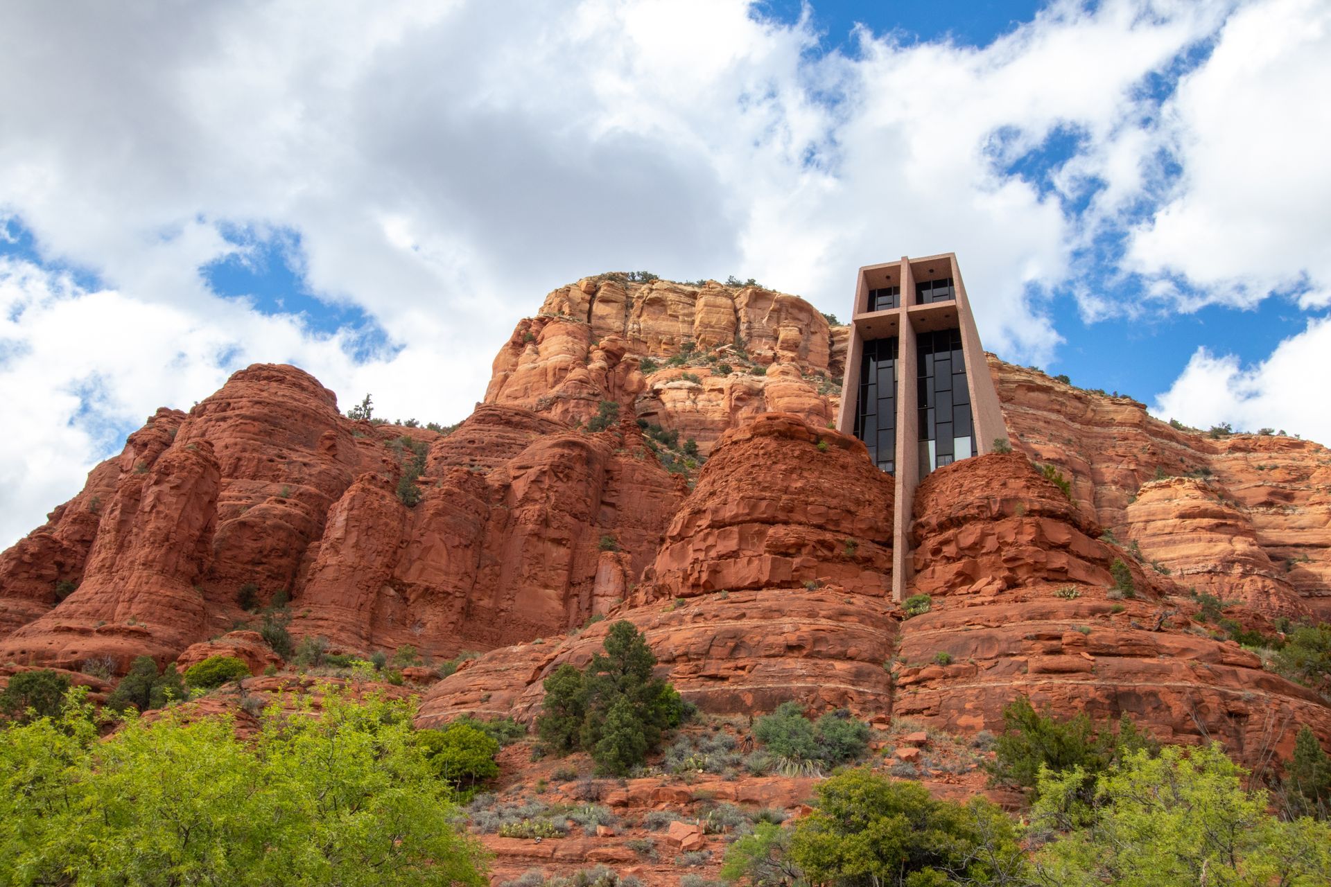 A church sitting on top of a red rocky mountain.