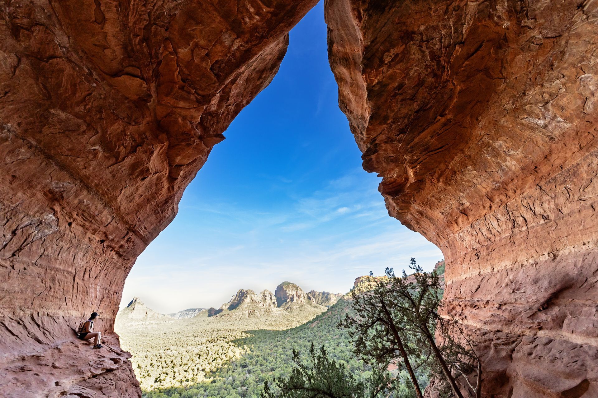 A view of a mountain range through the birthing cave