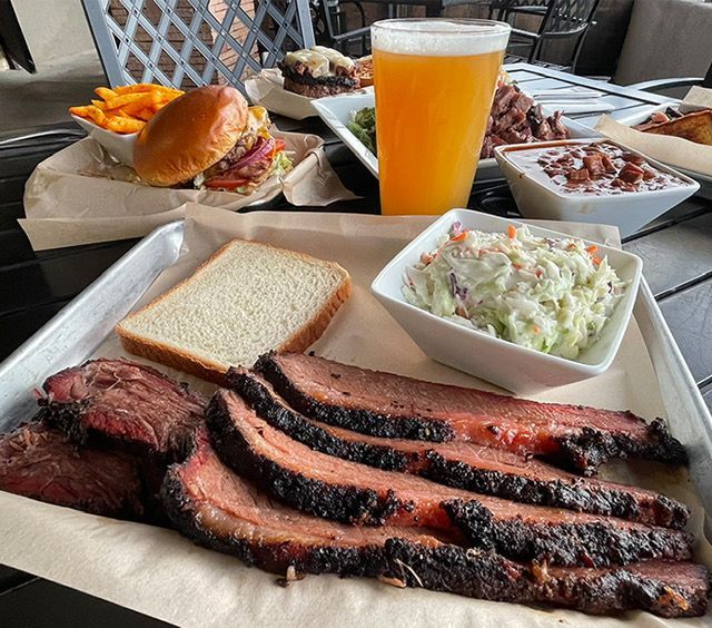 A plate of food with a hamburger and french fries on a table.