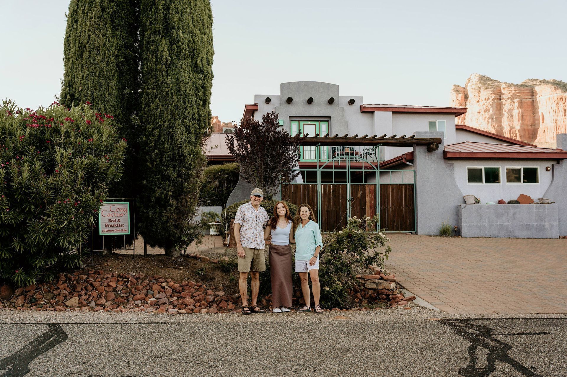 A family is standing in front of a house.