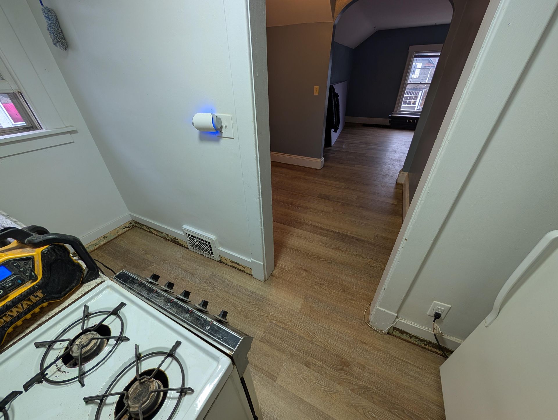 A stove top oven is sitting in a kitchen next to a doorway.