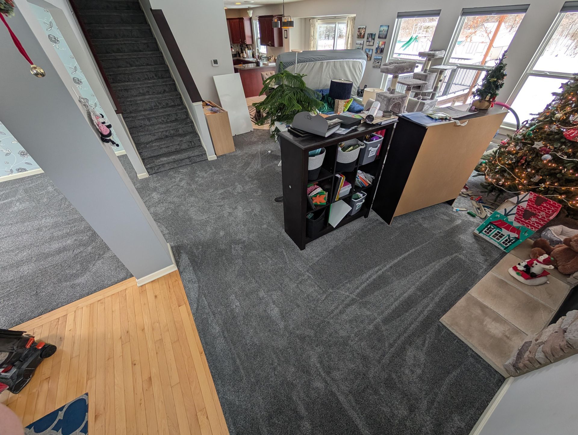 A living room filled with furniture and a christmas tree.