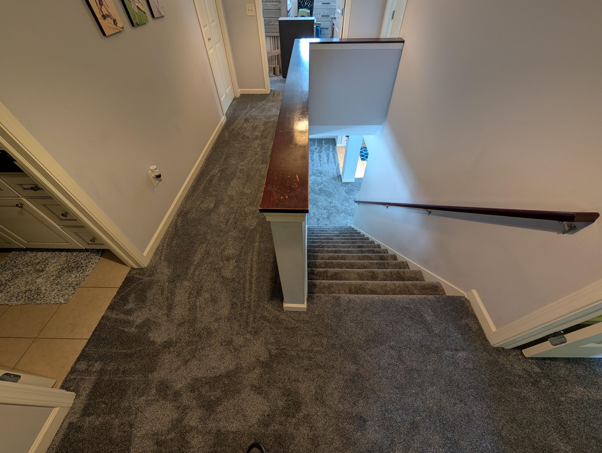A hallway with stairs leading up to the second floor of a house.