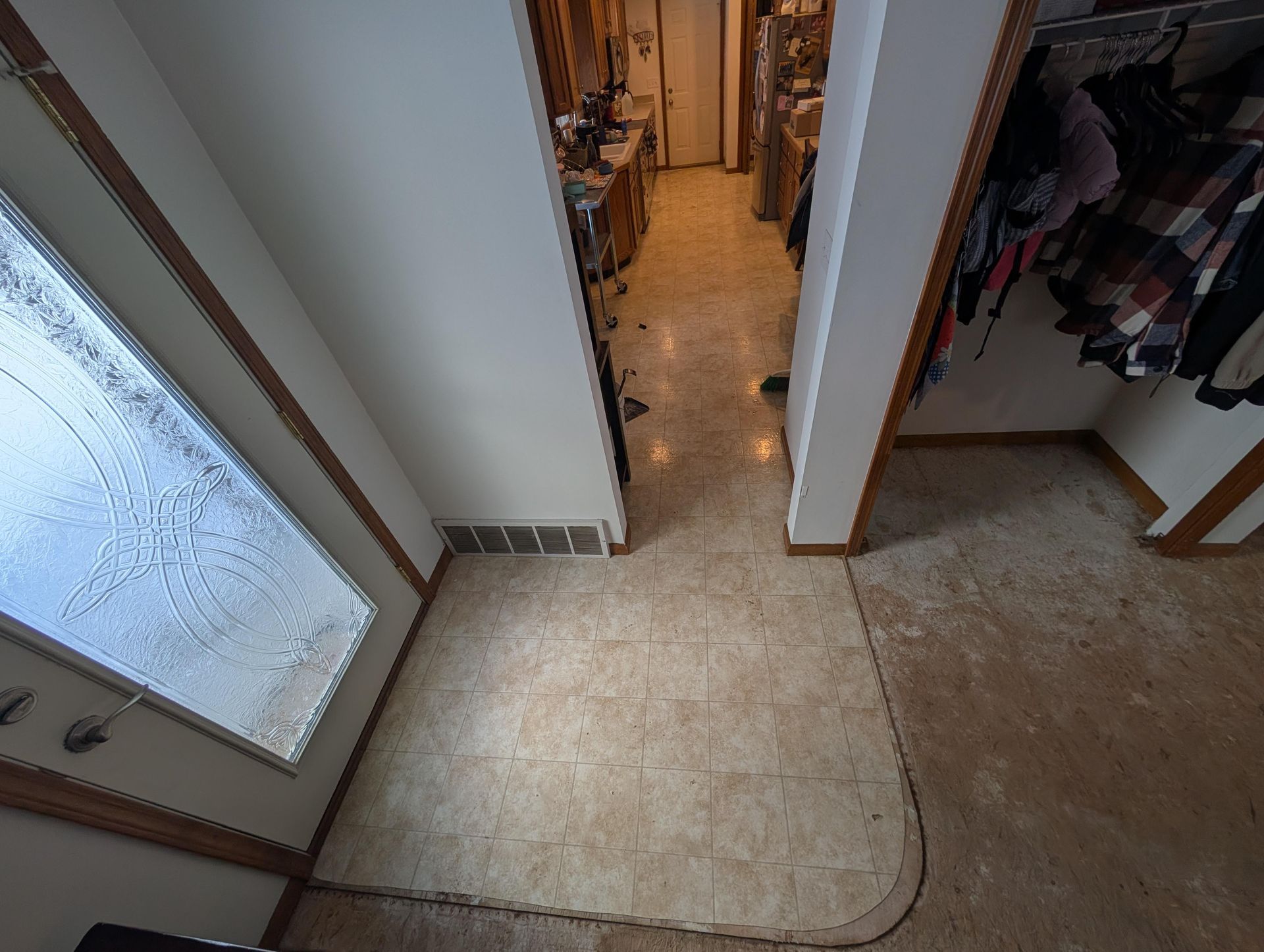 A hallway in a house with a closet and a door