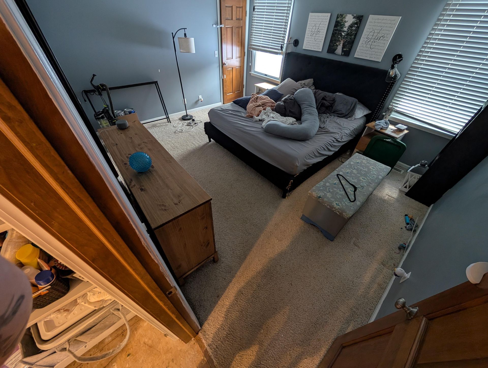 An aerial view of a bedroom with a bed and a dresser