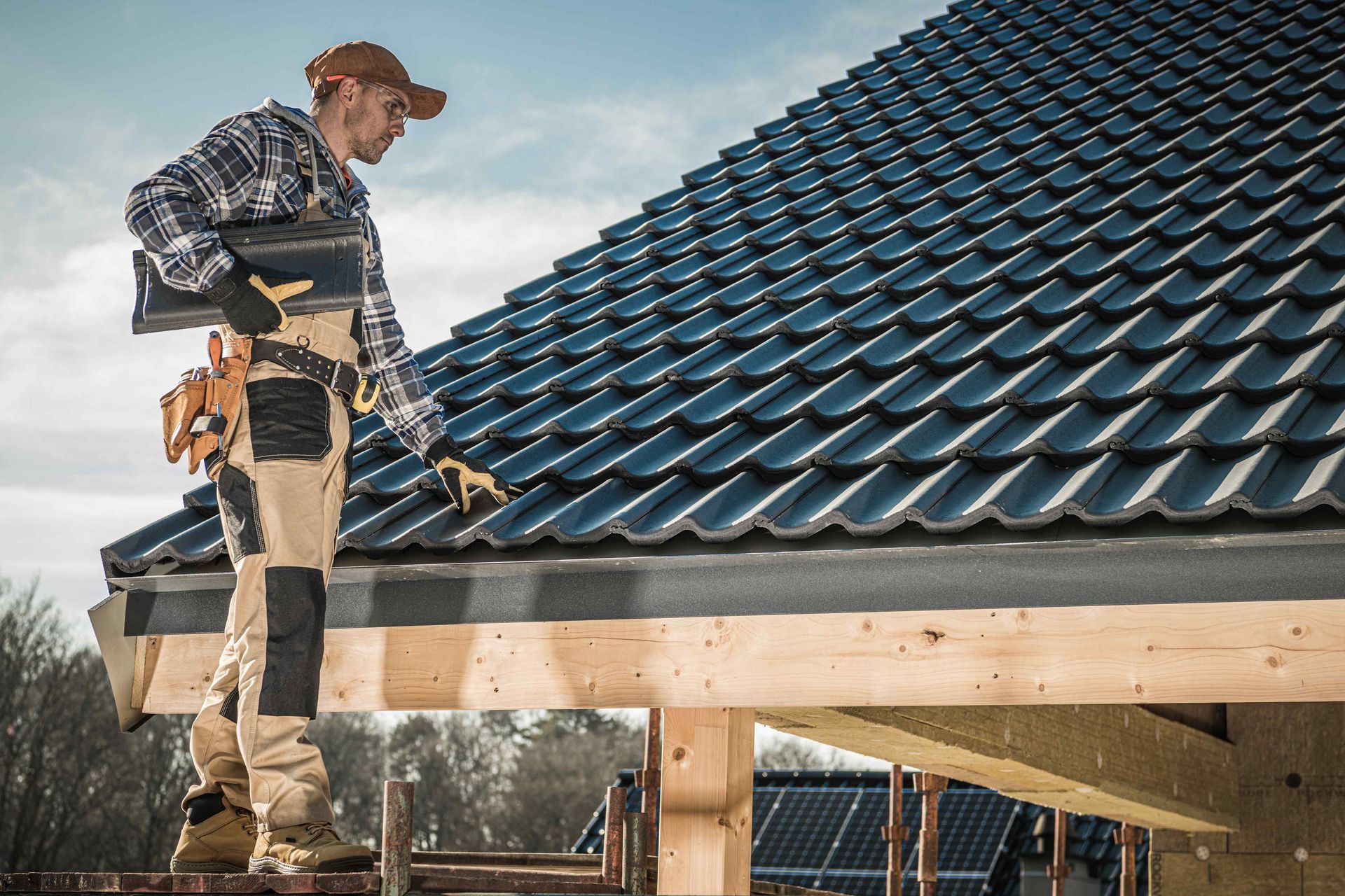 A man is standing on the roof of a building.