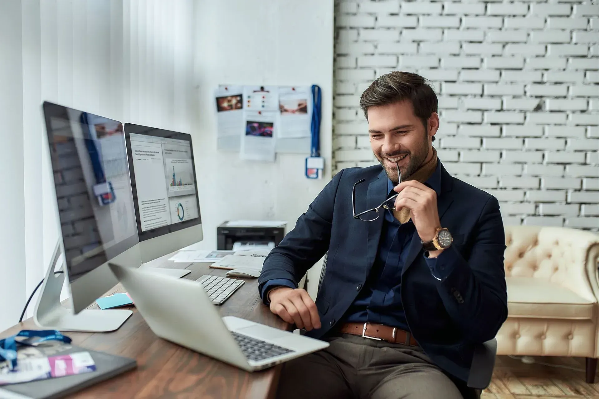 smiling man looking at his laptop