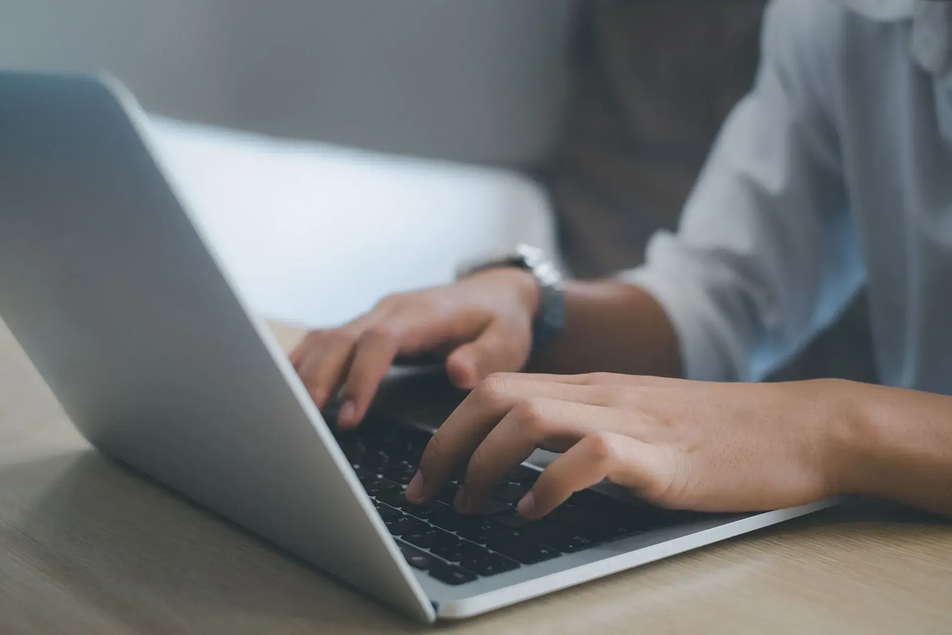 man typing on laptop