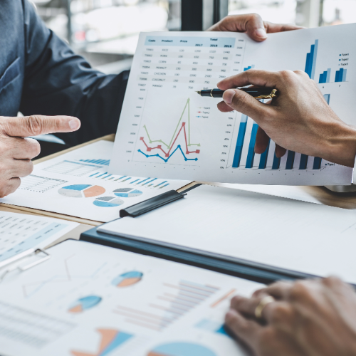 People reviewing financial data charts, pointing and discussing.