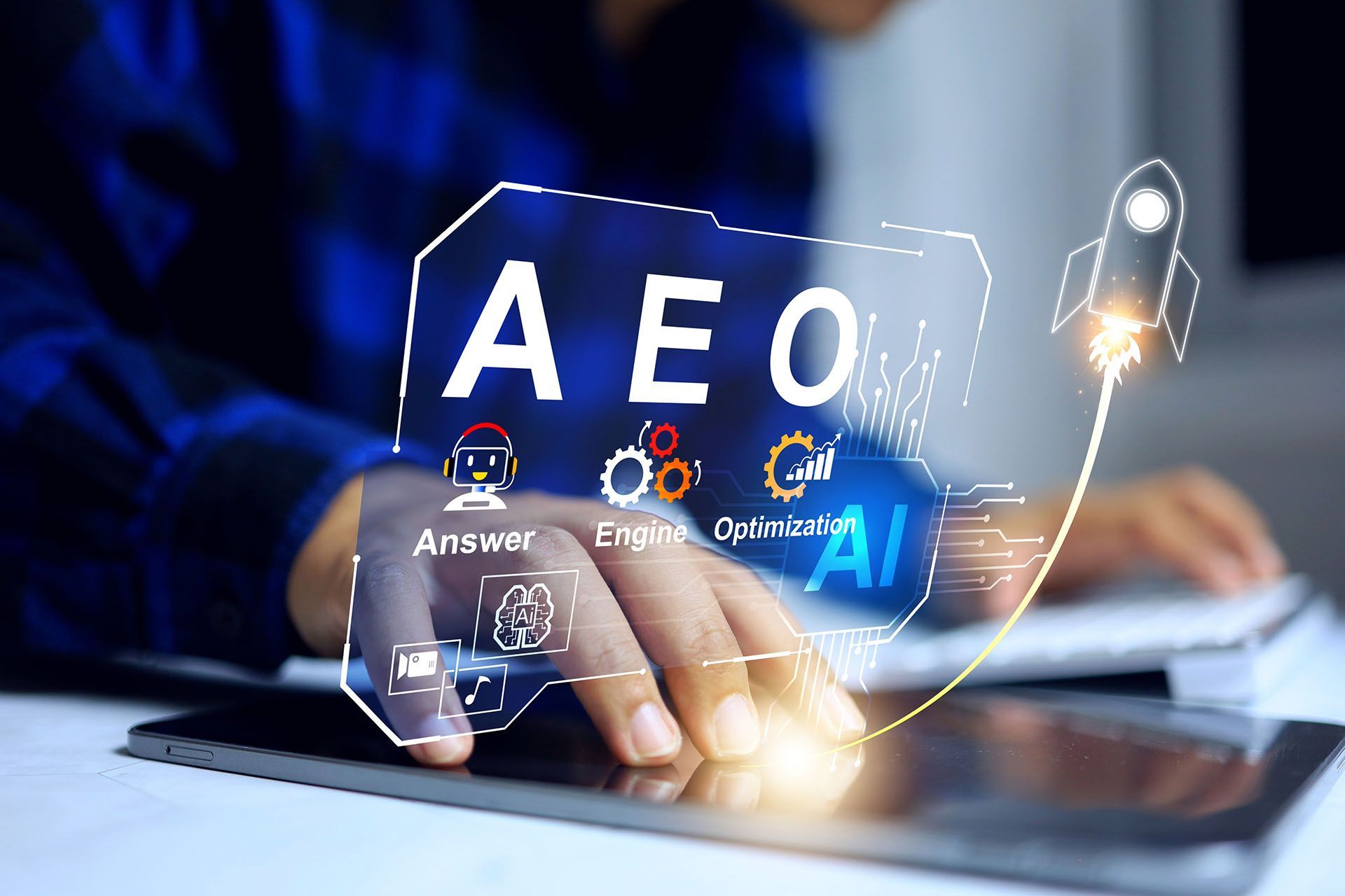 Person touching a tablet with a glowing digital overlay: AEO (Answer, Engine, Optimization, AI) graphic with a rocket launching.