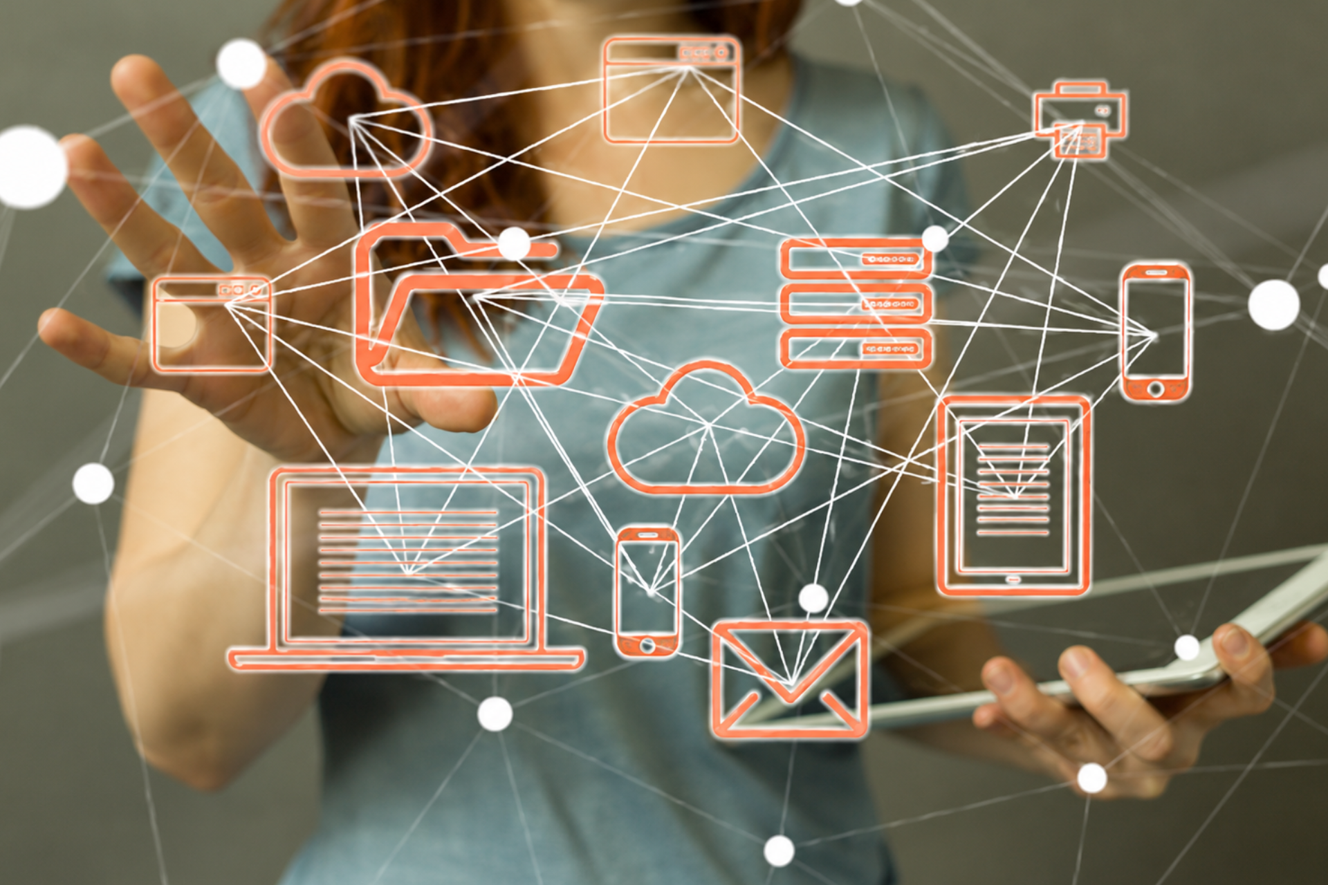 Hands holding a tablet with glowing network icons and connected app symbols overlayed
