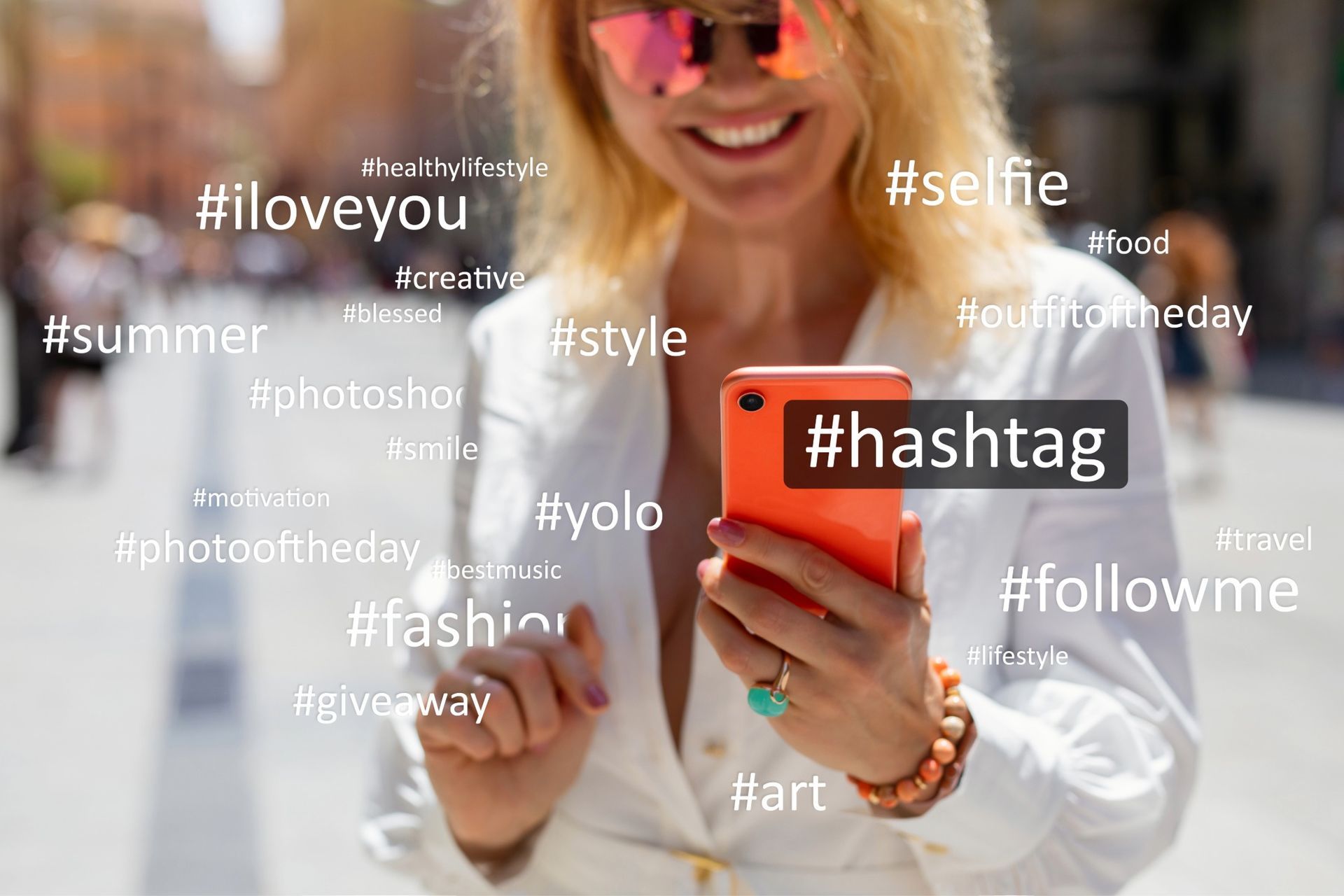 Woman smiling, holding a phone with hashtags like #selfie, #style, #fashion, and #hashtag.