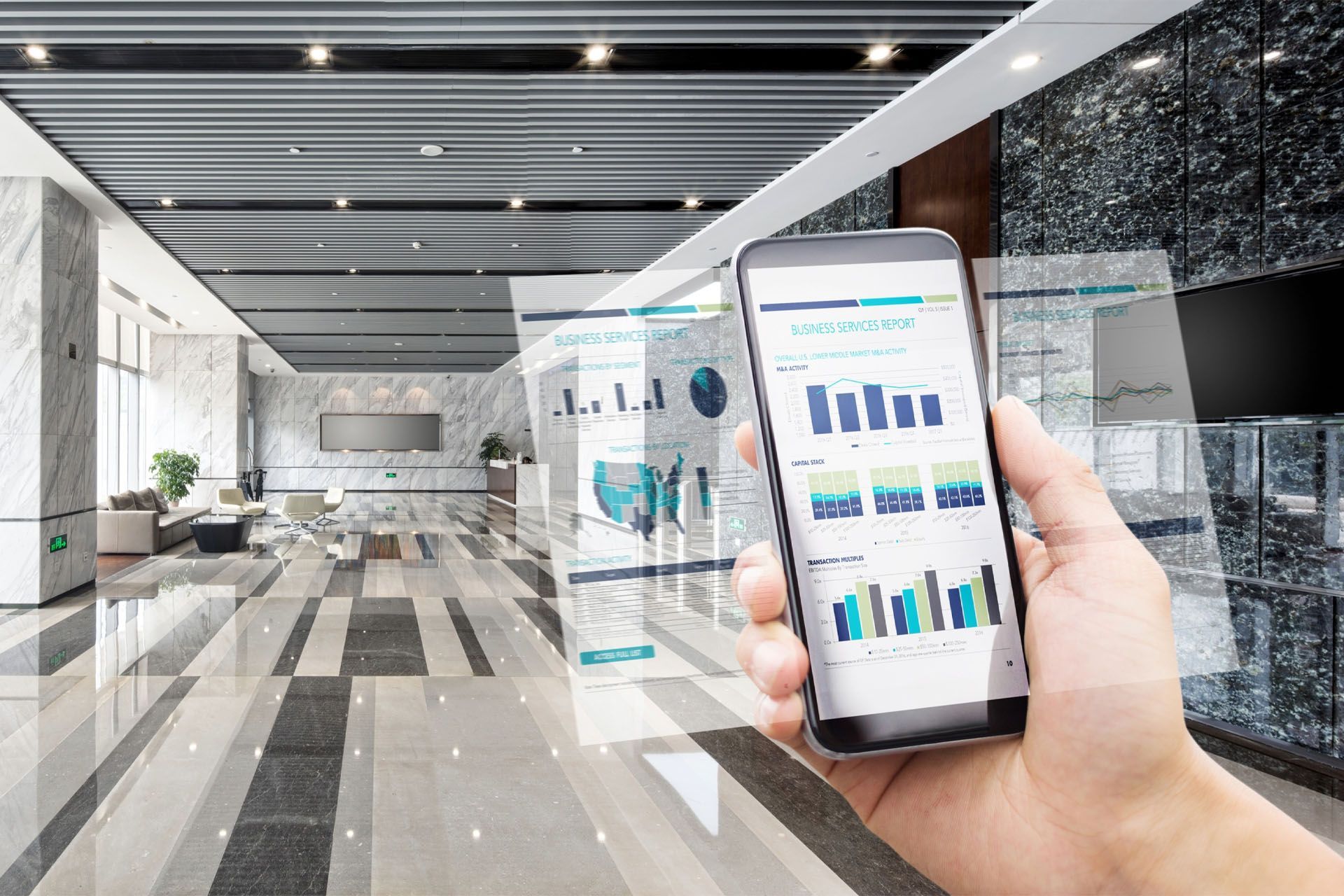 Hand holding smartphone displaying business charts in a modern office lobby.