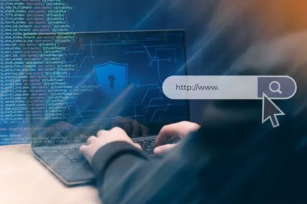 A person is typing on a laptop computer.