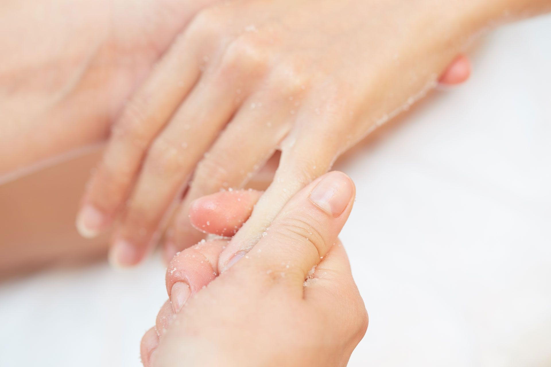 Hands being massaged with cream, a close-up shot.