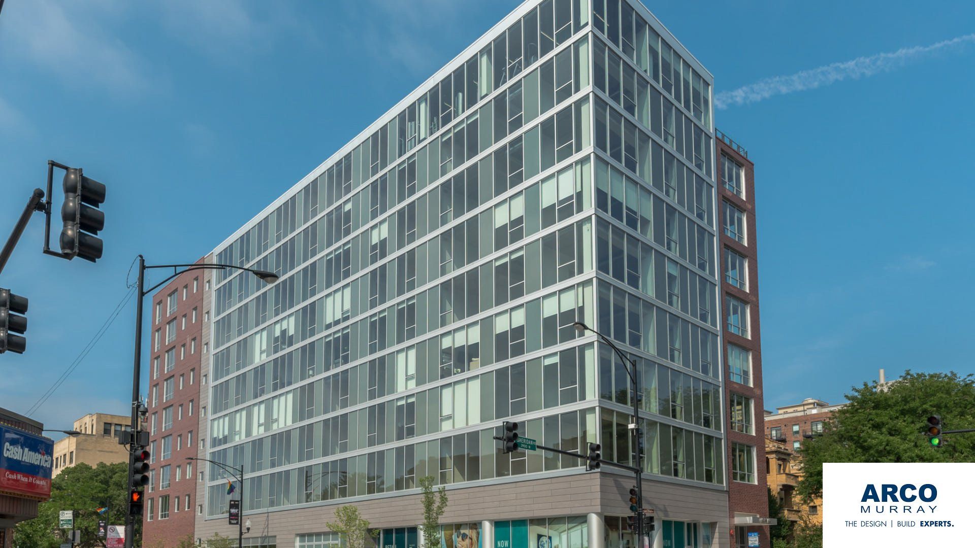 A large building with a lot of windows and a sign that says arco