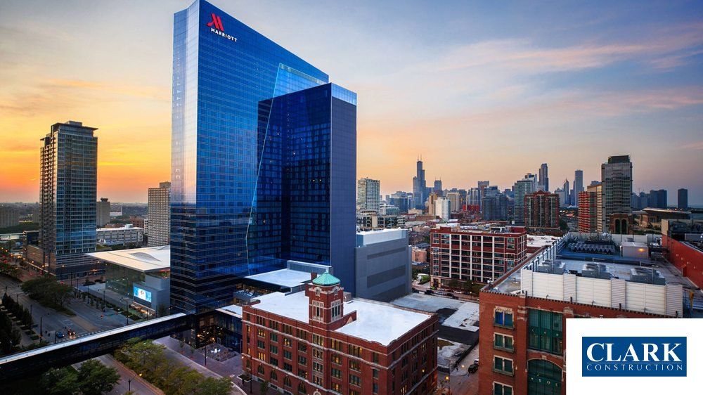 An aerial view of a city with a clark logo in the corner
