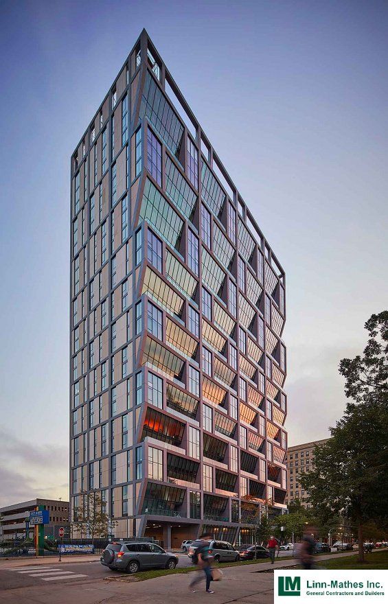 A tall building with a lot of windows and balconies.