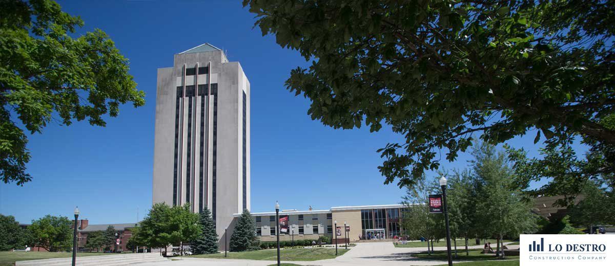 A large white building with a blue sky in the background