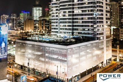 An aerial view of a large building in a city at night.