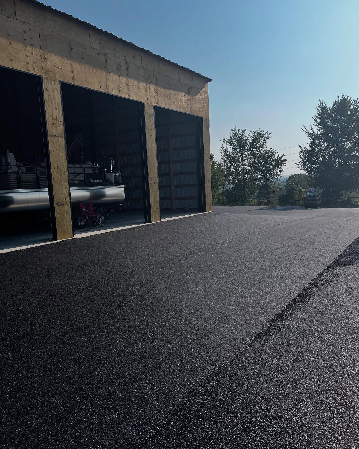 A row of garage doors with cars parked inside of them